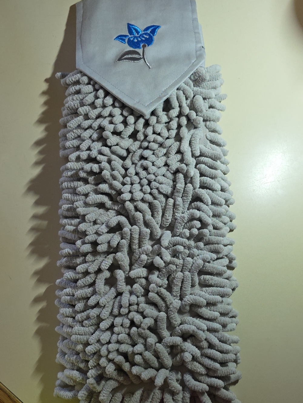 Norwex Chenille hand towel. New, Grey With Flower.